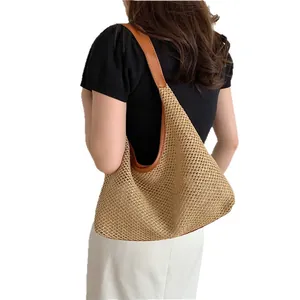 Minimalist retro woven straw tote bag with brown leather strap for women beach vacation.