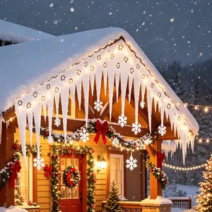 Christmas white foam icicle ornaments and snowflake pendants on snowy house eaves.