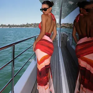 Sexy halter backless maxi dress with abstract sunset print shown on yacht deck