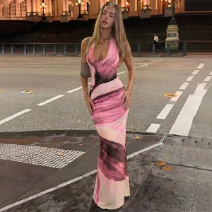 Detailed view of a stylish pink marble print halter-neck backless maxi dress on a model.