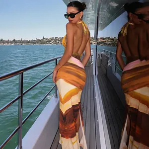 Elegant backless halter maxi dress with abstract sunset print and side slit detail