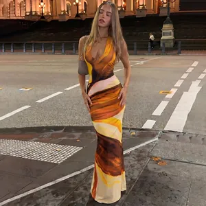 Detailed view of sleeveless printed maxi dress with abstract swirl pattern in orange and brown