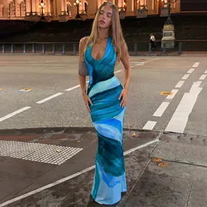 Full-length view of a sexy blue abstract print halter neck backless maxi dress.