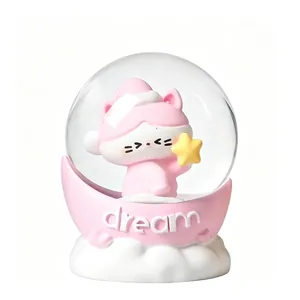 Cute pink cartoon cat snow globe decorative ornament with 'dream' text on white cloud base
