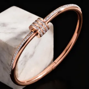 Elegant rose gold stainless steel bangle encrusted with sparkling rhinestones for women.