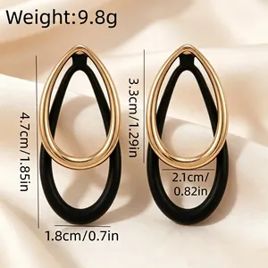 Detailed view of vintage gold and black teardrop earrings with precise dimensions