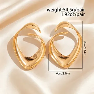 Detailed view of oversized gold hollow earrings showing weight and size measurements