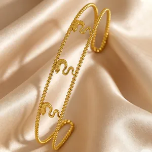 Luxury gold beaded stainless steel cuff bracelet featuring three snake motifs on silk