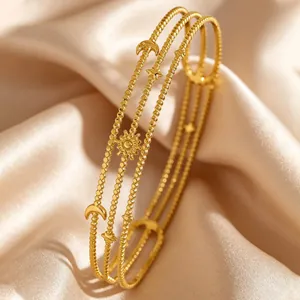 Close-up of luxury bohemian layered gold bracelet with star moon and sun charms