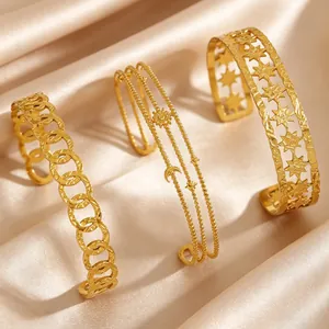 Set of three vintage gold-plated stainless steel bangles with bohemian star and moon designs.