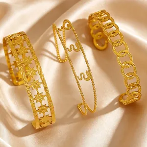 Detailed close-up view of three vintage gold-toned stainless steel bangles on silk.