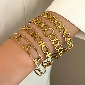 Detailed shot of stacked vintage bohemian gold-tone stainless steel bracelets on wrist