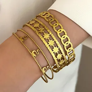 Detailed close-up view of stacked gold bohemian stainless steel bracelets on a female wrist