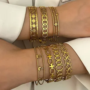 Detailed view of layered bohemian gold stainless steel bracelets with celestial charms