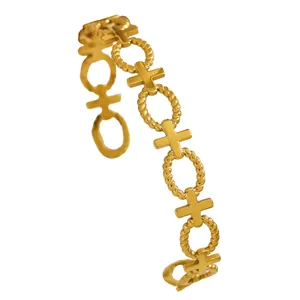 Macro detail of a vintage gold-plated stainless steel cuff bracelet with rope patterns
