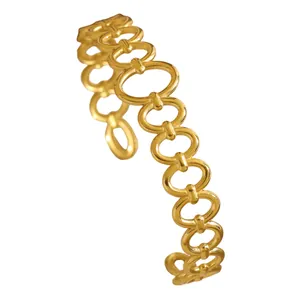 Detailed view of bohemian gold-plated stainless steel cuff featuring linked oval ring design