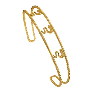Detailed macro shot of a vintage gold-toned double beaded bracelet featuring snake motifs