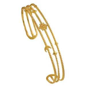 Close-up of bohemian gold stainless steel triple-layer beaded bracelet with celestial charms
