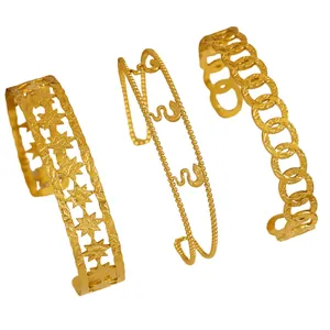 Detailed view of three different vintage gold-plated stainless steel cuff bracelets.