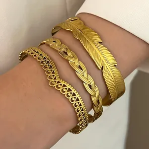 Stackable vintage gold stainless steel bangles set with feather and braided patterns