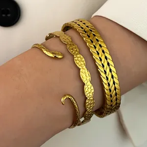 Detailed close-up of vintage gold stainless steel bracelets in a stacked style