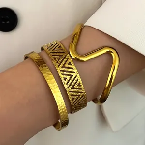 Stacking set of gold stainless steel bangles with bohemian geometric and wavy designs