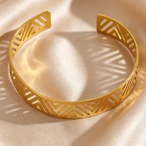 Close-up of vintage stainless steel cuff bracelet with boho geometric cutouts