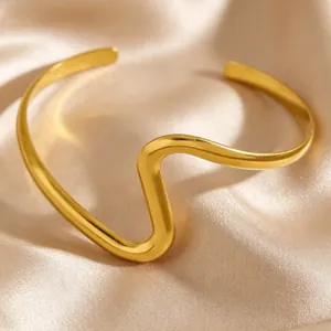 Detailed view of the elegant wave-shaped golden stainless steel cuff bracelet
