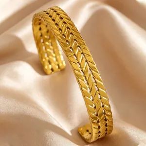 Elegant close-up of a vintage gold wheat pattern stainless steel cuff bracelet on satin