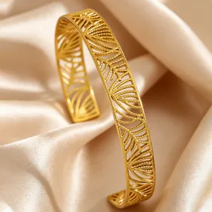 Detailed close-up of a vintage Bohemian gold cuff bracelet with leaf patterns