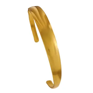 Detailed side view of a vintage gold-toned stainless steel cuff bracelet with smooth finish.