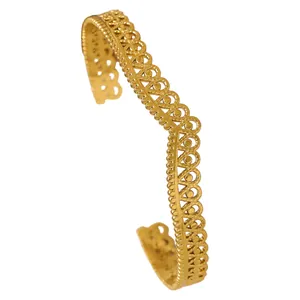 Close-up of vintage bohemian style gold stainless steel filigree cuff bracelet in V-shape
