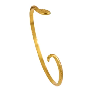 Close-up of a golden stainless steel snake bracelet featuring an intricate scale texture