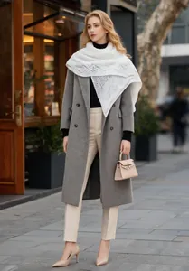 Elegant white hollow knit shawl scarf draped over a grey wool coat for street style