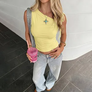 Detailed view of a yellow one-shoulder sleeveless cropped top with ruched texture.