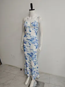 Elegant blue floral print mesh maxi dress with a ruched mermaid hem on mannequin.