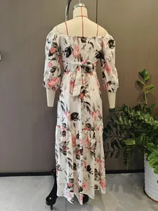Vista posteriore di un elegante abito lungo a fiori con dettaglio in vita e gonna fluida.