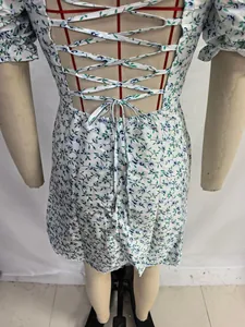 Vue détaillée du dos lacé d'une robe fleurie blanche à manches bouffantes style français