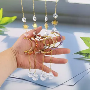Set of four celestial moon sun catchers with crystals and raw stones held in hand