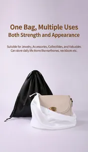 Close-up of black and white satin drawstring bags for jewelry and accessory storage.