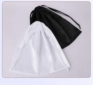 Detailed view of black and white satin drawstring pouches for jewelry or hair extensions