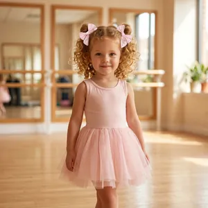 Adorable young girl wearing pink embroidered ballet dancer bow hair clips in a dance studio