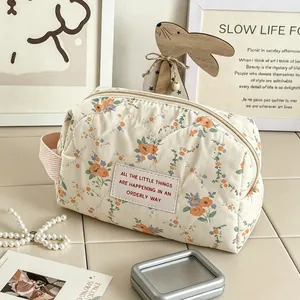 Quilted floral cosmetic bag with quote patch in cream apricot finish