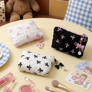 Cute quilted makeup bags with bow patterns and elegant pearl charms in three colors