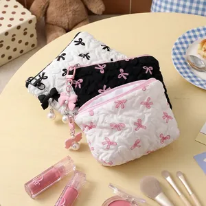 Set of quilted bow cosmetic storage bags with pearl pendants in elegant colors