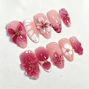 Premium handmade floral press-on nails featuring a pink blush effect and delicate pearl accents