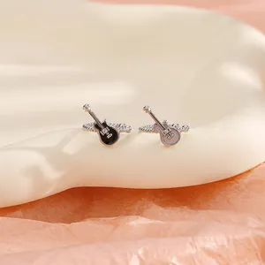 Detailed close-up view of black and white guitar ear clips featuring silver textured bands