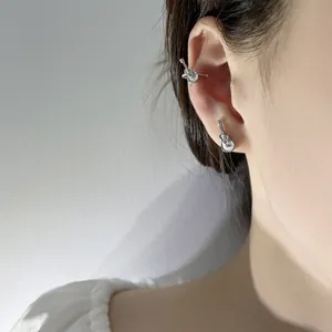 Professional close-up of a silver guitar-shaped earring and ear cuff jewelry set