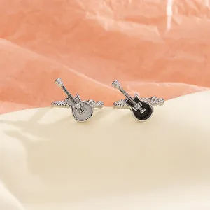 Unique retro punk guitar-shaped ear clips in black and white music theme style