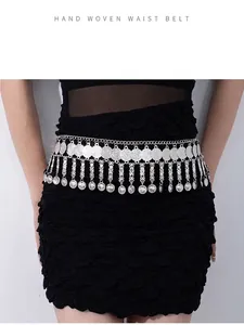 Detailed view of bohemian style silver metal waist chain with vintage coin tassels